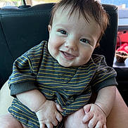 Beau joined the competition — help win amazing prizes! baby, child, smiling, happy, striped_clothing, infant, cute, portrait, sitting, hands, face, person, indoors, car_seat, head, skin, eyebrows, eyelashes, natural_light, young