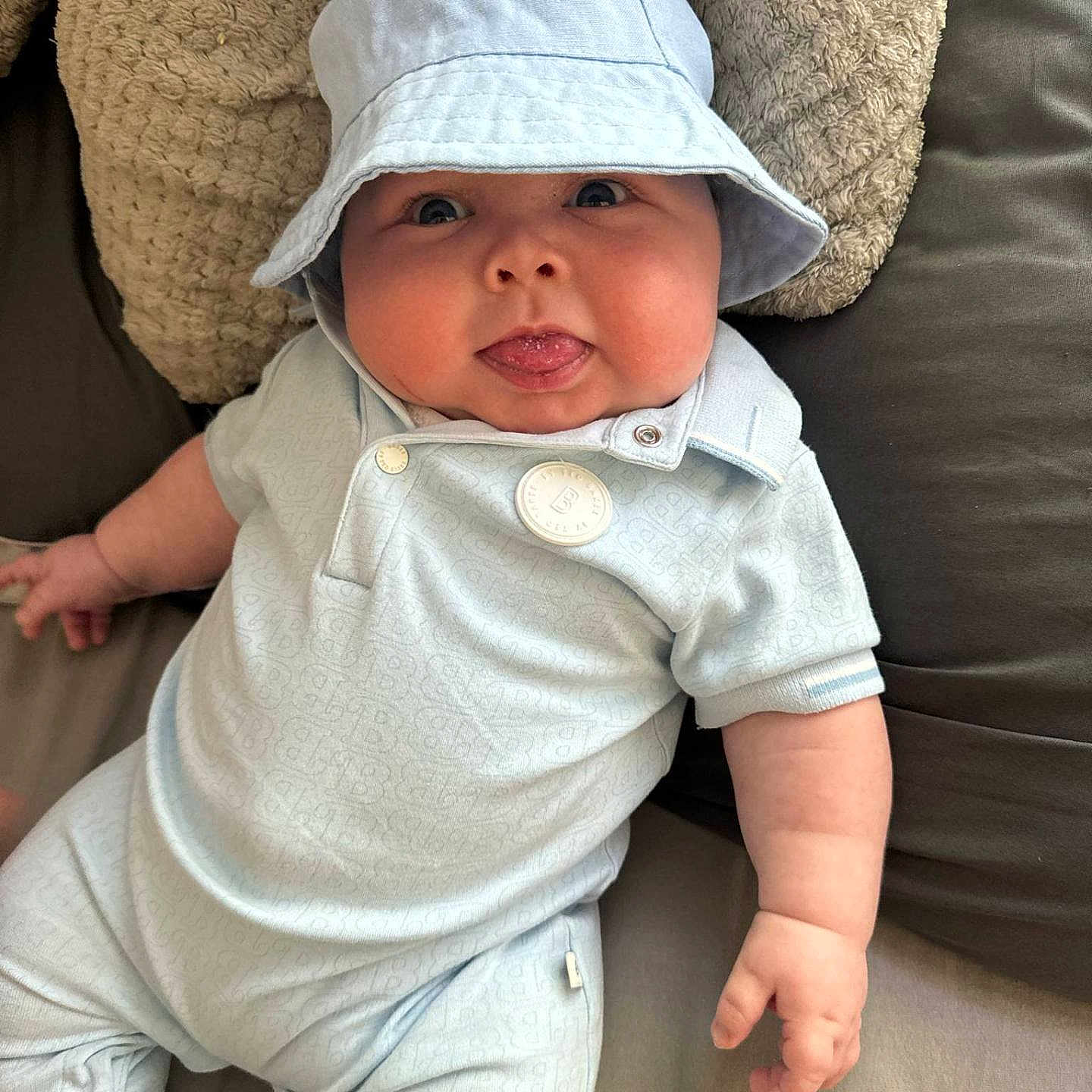 Brogan joined the competition — help win amazing prizes! baby, bonnet, cap, clothing, couch, cushion, face, furniture, hat, head, homedecor, hood, jeans, newborn, pants, person, photography, portrait, sleeve, sunhat