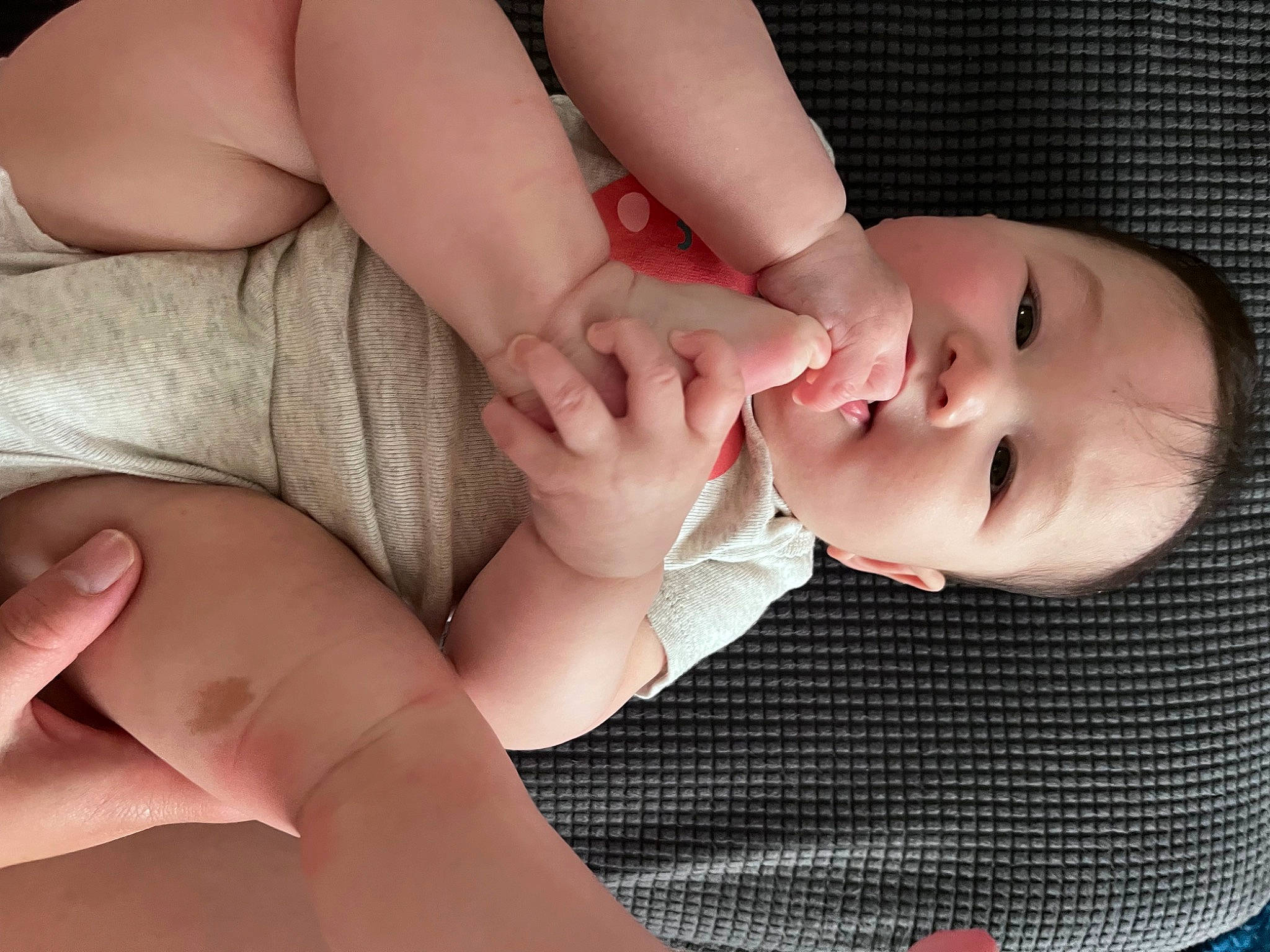 Emma is registered to the contest to win money with this photo: baby, baby_toddler_clothing, cheek, chest, child, comfort, elbow, eyelash, finger, gesture, hand, joint, leg, mouth, nail, pattern, person, skin, thumb, toddler