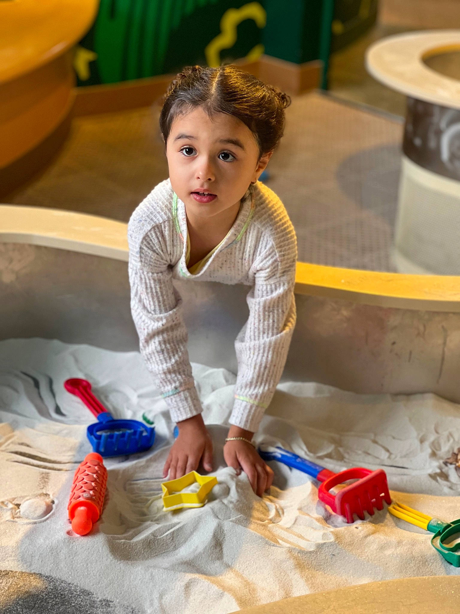 Valerie is registered to the contest to win money with this photo: child, comfort, flooring, fun, glass, happy, leisure, pattern, person, plastic, plastic_bag, plastic_bottle, play, recreation, science, service, sitting, soil, vacation, water_bottle