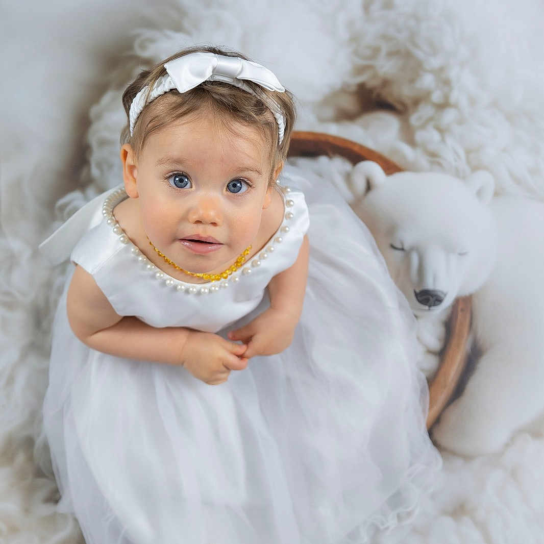 Iziya participe au concours pour gagner de l'argent avec cette photo : accessories, angel, animal, baby, blanket, canine, clothing, dog, dress, face, happy, head, headband, newborn, person, pet, photography, portrait, smile, toy