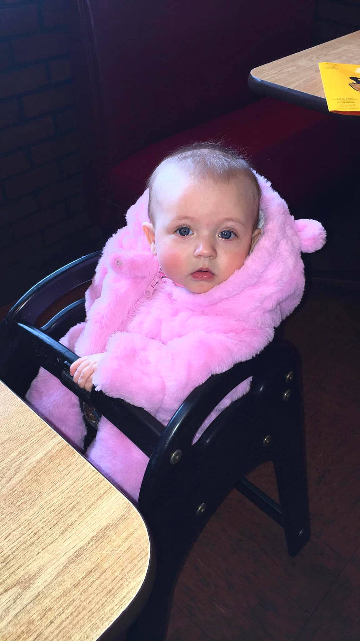 Kaliah is registered to the contest to win money with this photo: baby, baby_carriage, baby_toddler_clothing, chair, cheek, chin, comfort, eye, eyebrow, hairstyle, human_body, iris, lap, lip, magenta, mouth, person, pink, skin, surprise