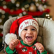 Elias joined the competition — help win amazing prizes! baby, child, smiling, christmas, holiday, santa_hat, festive_clothing, high_chair, happy, portrait, indoors, celebration, cute, infant, toothy_grin, red, green, seasonal, family, joy