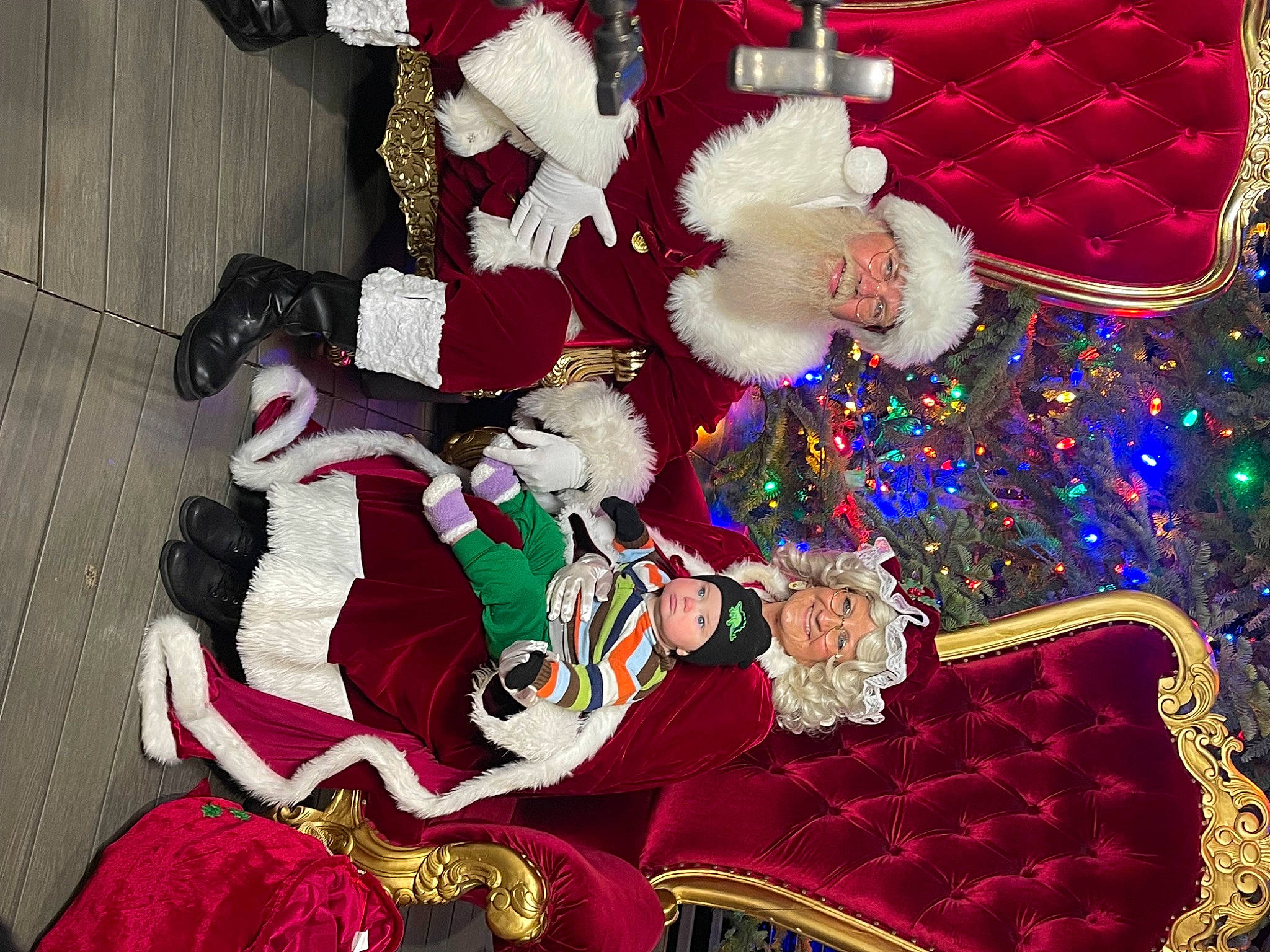 Raymond is registered to the contest to win money with this photo: carmine, christmas, christmas_decoration, christmas_eve, christmas_ornament, decoration, event, fictional_character, fur, headwear, holiday, interior_design, joy, lap, magenta, ornament, pattern, person, red, room