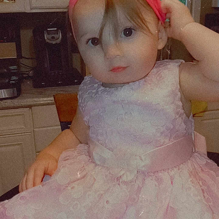 Aaliyah is registered to the contest to win money with this photo: accessories, baby, bonnet, clothing, costume, couch, dress, eveningdress, face, fashion, formalwear, furniture, gown, head, headband, lace, person, photography, portrait, toy