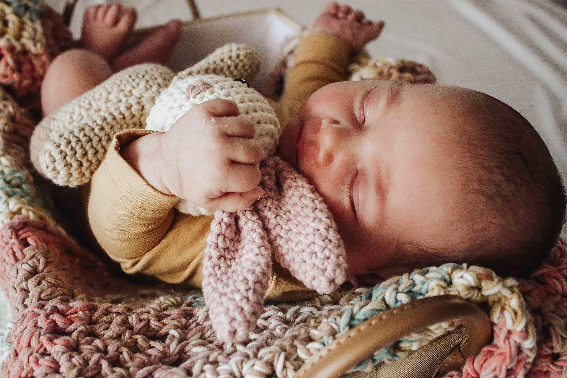 Olivia is registered to the contest to win money with this photo: arm, baby, baby_sleeping, baby_toddler_clothing, child, comfort, eyelash, fashion_accessory, gesture, grass, linens, nail, pattern, person, skin, textile, thumb, toddler, wood, wool