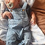 Reggie is registered to the contest to win money with this photo: baby, infant, pacifier, denim_overalls, blue_blanket, brown_blanket, socks, sleepy, lying_down, soft_texture, cute, child, portrait, cozy, indoors, newborn, relaxed, clothing, small_hands, peaceful