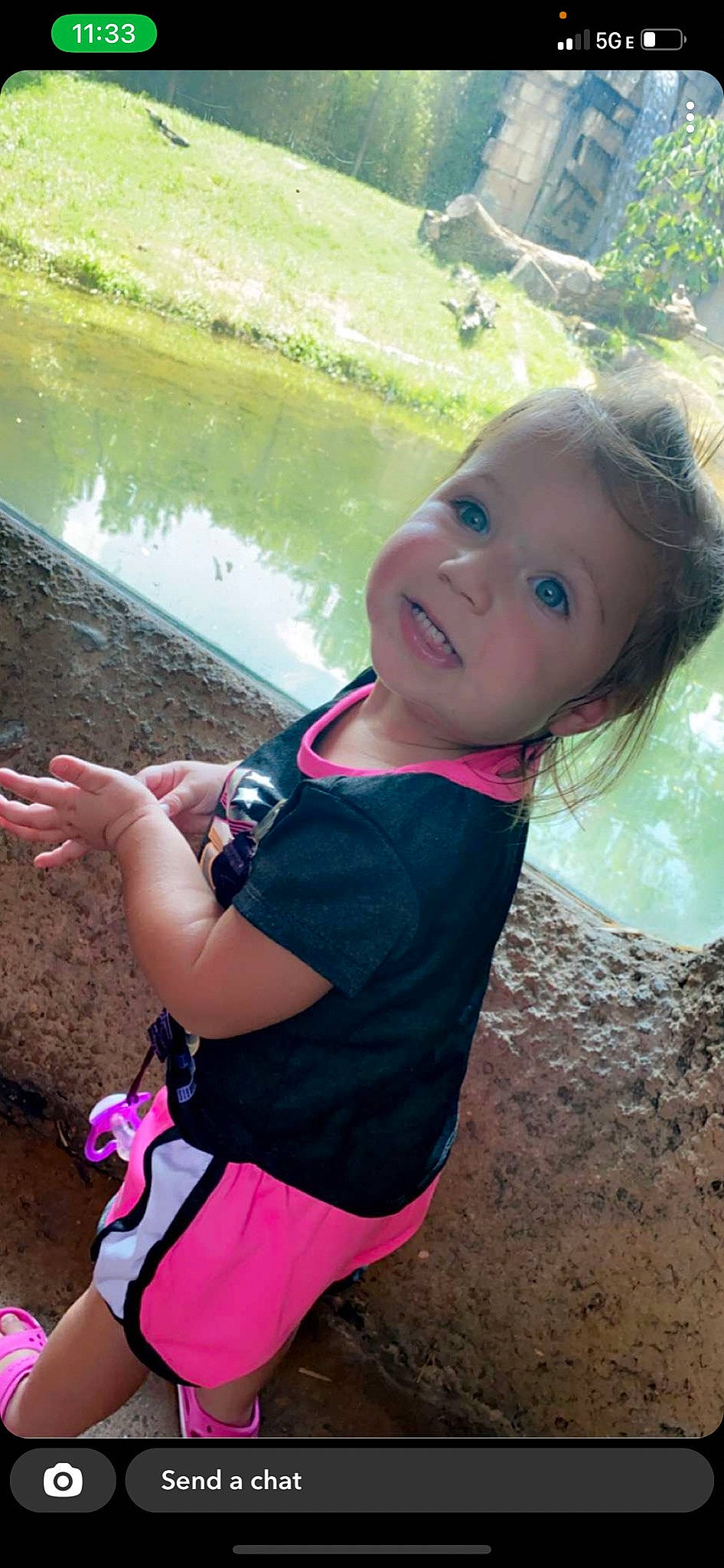 Mackenzie is registered to the contest to win money with this photo: beauty, child, cool, fun, grass, hand, happy, lake, leaf, leisure, mouth, person, pink, plant, recreation, skin, smile, t_shirt, toddler, travel