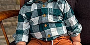Lucas joined the competition — help win amazing prizes! baby, brown, casual_clothing, chair, child, comfortable, cushion, cute, green, happy, indoors, pants, plaid, portrait, seated, shirt, smiling, stone_wall, toddler, wood