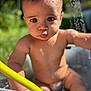 baby, child, water, outdoor, sunlight, tub, skin, face, eyes, arm, hand, diaper, nature, summer, cute, playing, sitting, water_droplets, expression, closeup