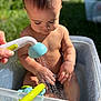 Lucas joined the competition — help win amazing prizes! baby, child, closeup, curious, fun, garden, greenery, hands, nature, outdoor, person, plastic_tub, play, skin, summer, sunlight, toddler, water, water_droplets, watering_can