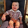 baby, smiling, child, rocking_chair, cushion, shirt, suspenders, pants, barefoot, happy, portrait, indoor, furniture, cute, young_child, sitting, sunlight, face, skin, wood