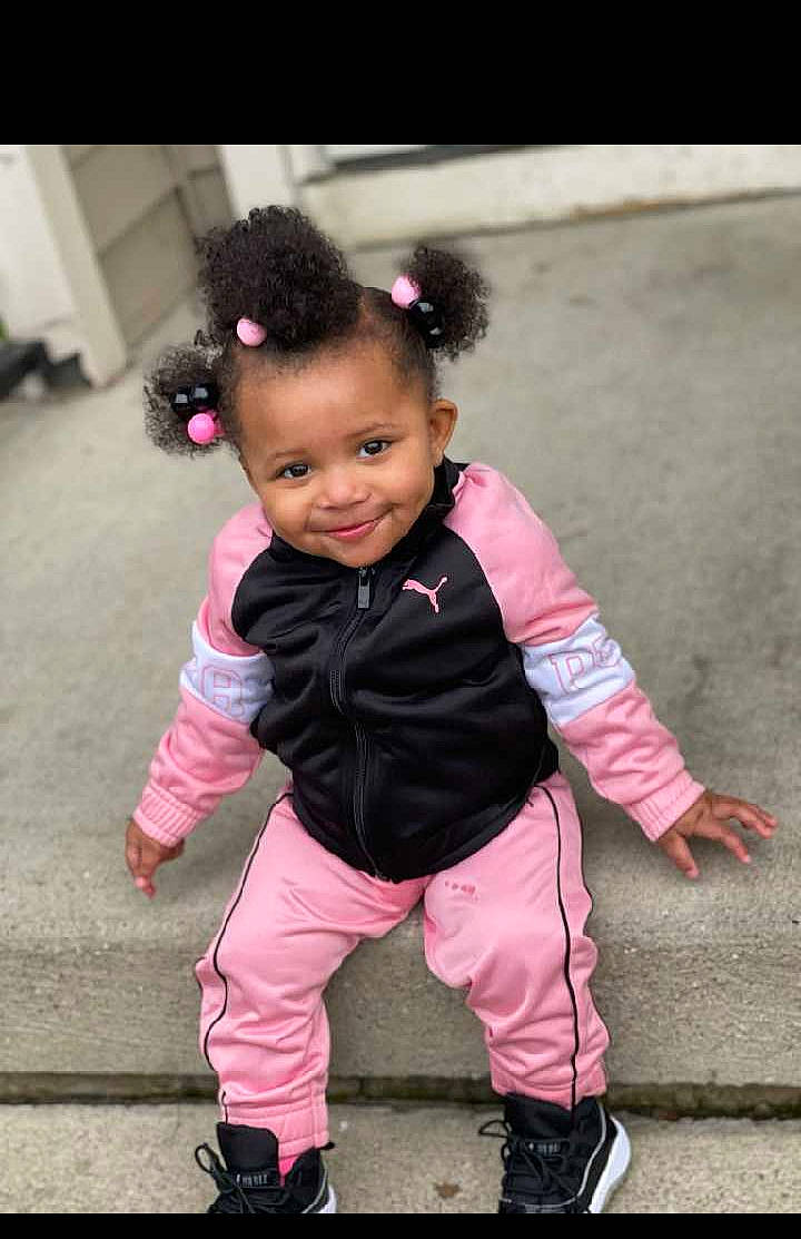 Ariel Jones is registered to the contest to win money with this photo: baby, baby_toddler_clothing, cheek, child, face, flash_photography, fun, happy, joy, magenta, person, pink, purple, sandal, shoe, sitting, skin, sleeve, smile, sneakers