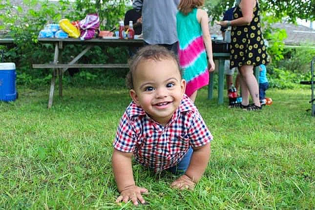 Jayden is registered to the contest to win money with this photo: baby, clothing, crawling, dress, event, fun, grass, green, happy, joy, lawn, leaf, leisure, people_in_nature, person, plant, recreation, shorts, smile, summer