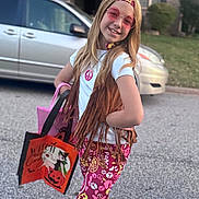 Blaire is registered to the contest to win money with this photo: child, girl, outdoor, sunglasses, fringe_vest, colorful_pants, halloween_bag, smile, pose, street, car, headband, peace_sign, long_hair, fashion, holiday, fun, costume, accessories, daylight