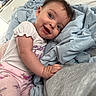 baby, child, infant, bed, blanket, clothing, cute, expression, face, floral, happy, indoors, infant_girl, laying, person, pink, portrait, shirt, smile, toddler