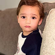 Idrees joined the competition — help win amazing prizes! toddler, child, portrait, face, eyes, couch, pillow, indoor, casual_clothing, soft_lighting, young, person, sitting, expression, hair, skin, closeup, cute, relaxed, home