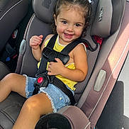 Everleigh joined the competition — help win amazing prizes! toddler, child, car_seat, smiling, yellow_top, denim_shorts, hair_buns, white_ribbons, seatbelt, car_interior, sunlight, cute, happy, portrait, safety, seat_cup_holder, car_door, window, young_child, casual_clothing