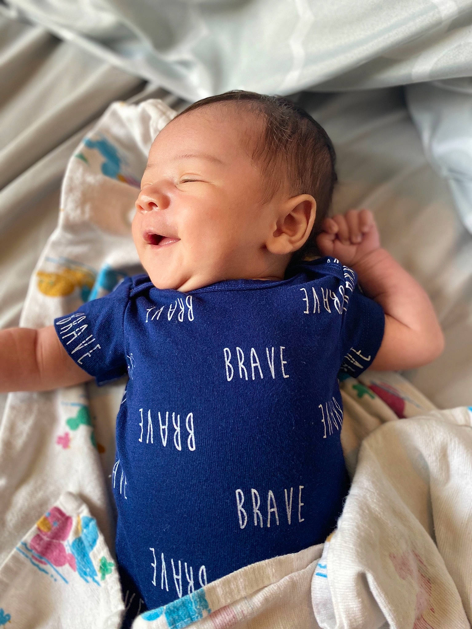 Elias Callwood is registered to the contest to win money with this photo: baby, baby_products, baby_toddler_clothing, birth, cheek, child, cloud, cool, face, facial_expression, happy, head, nose, person, product, skin, sleep, sleeve, smile, t_shirt