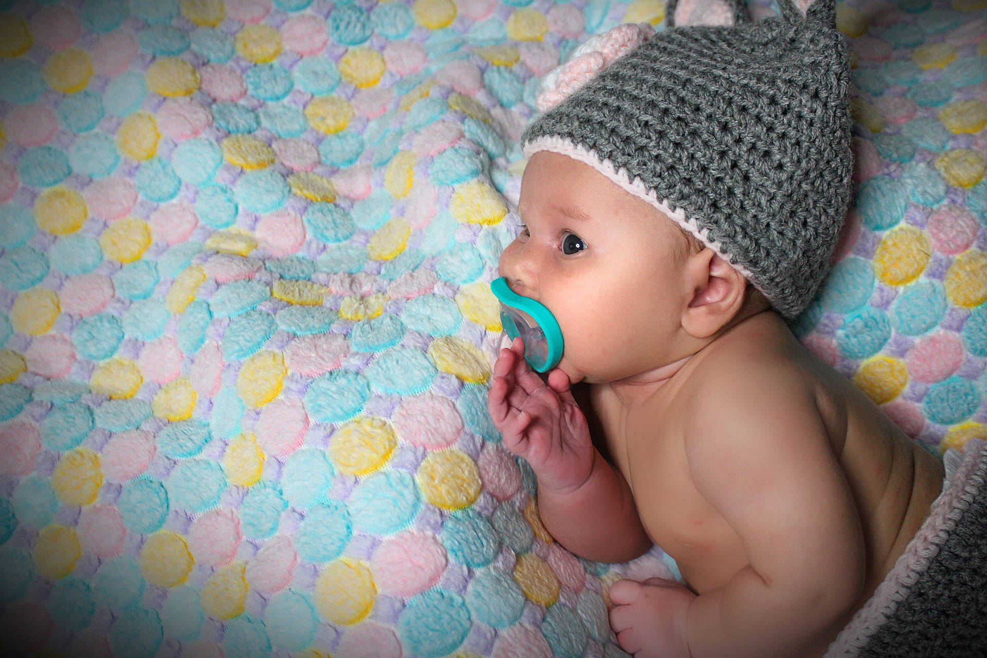 Guinevere is registered to the contest to win money with this photo: azure, baby, baby_toddler_clothing, cap, cheek, comfort, face, fun, grass, hand, happy, head, headwear, leaf, linens, nail, pattern, person, pink, skin