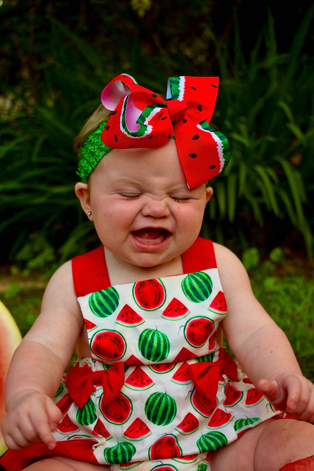 Everleigh Kate is registered to the contest to win money with this photo: baby, baby_toddler_clothing, cap, child, costume_hat, event, face, fun, goggles, grass, happy, head, headwear, magenta, pattern, people_in_nature, person, pink, plant, red