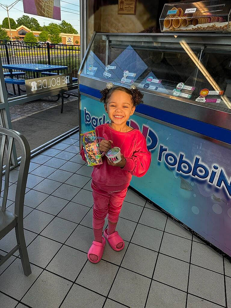 Amina Nikole is registered to the contest to win money with this photo: advertising, baby, baby_toddler_clothing, child, city, flooring, fun, happy, joy, leisure, logo, magenta, market, person, recreation, sidewalk, street, t_shirt, toddler, tourism