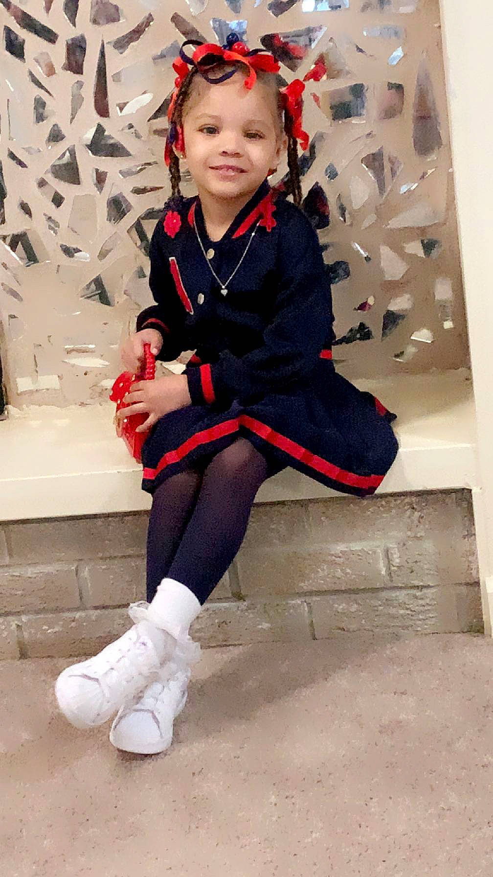 Amina Nikole joined the competition — help win amazing prizes! baby_toddler_clothing, carmine, child, costume, fashion_accessory, fashion_design, formal_wear, fun, happy, human_leg, joy, knee, leg, pattern, person, sitting, sleeve, smile, sock, thigh