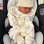 baby, sleeping, car_seat, infant, hat, striped_hat, animal_print, onesie, cozy, newborn, white_clothing, cute, child, footwear, socks, seat_belt, safety, resting, indoor, portrait