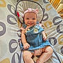 baby, baby_seat, child, clothing, cute, denim_dress, furniture, happy, headband, home, indoor, infant, light, patterned_fabric, person, pink, portrait, seat, smiling, tongue_out