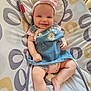 baby, child, clothing, cushion, cute, denim_dress, face, foot, hand, happy, headband, indoors, infant, legs, patterned_fabric, pink, portrait, relaxed, sitting, smiling