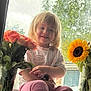 Ava joined the competition — help win amazing prizes! child, toddler, window, flowers, bouquet, sunflower, roses, pink_pants, white_shirt, smile, sitting, natural_light, indoors, greenery, glass_vase, happy, portrait, cute, casual_clothing, daylight