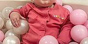 Elsie joined the competition — help win amazing prizes! baby, child, pink_outfit, ball_pit, plastic_balls, indoor, cute, portrait, infant, playtime, soft_toys, happy, childhood, smiling, face, hand, seated, looking_up, cozy, adorable