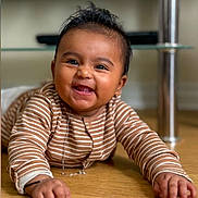 Elenora joined the competition — help win amazing prizes! baby, smiling, child, striped_clothing, floor, happy, indoors, portrait, face, cute, toddler, skin, eyebrows, mouth, hand, young_child, lying_down, expression, bright_eyes, person