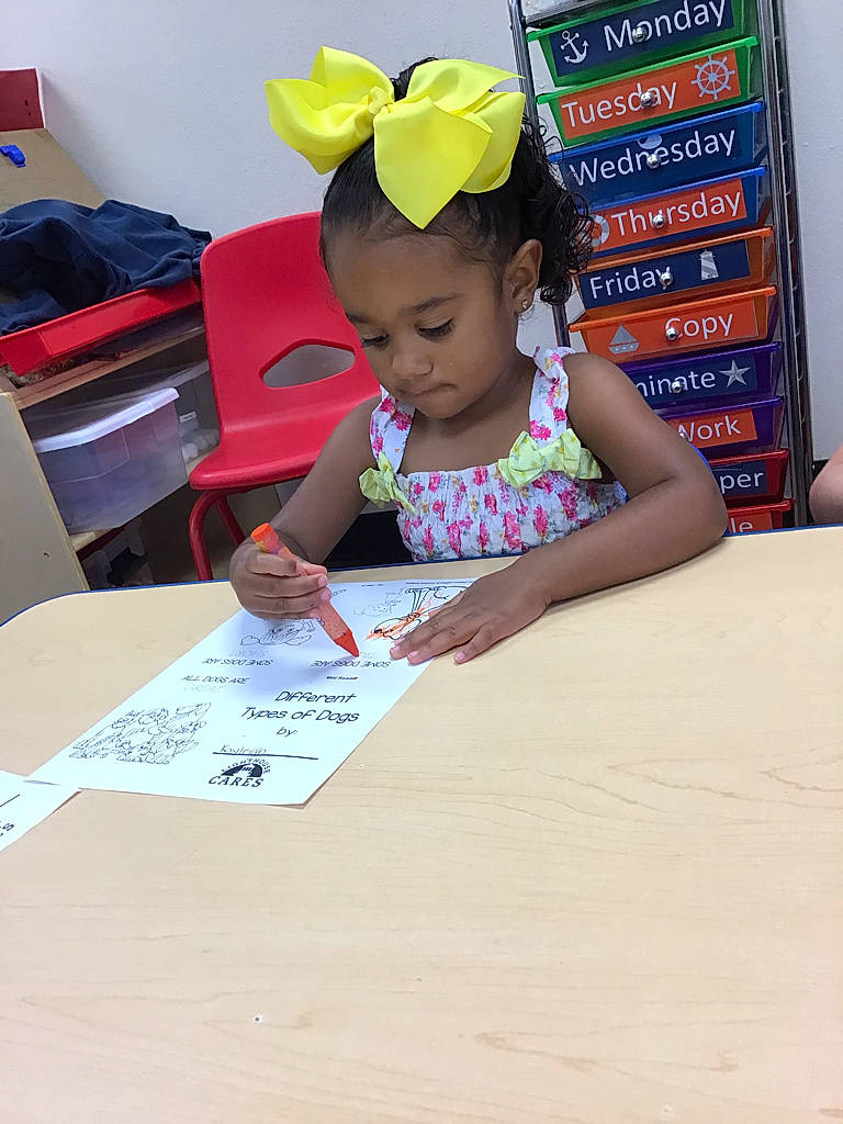 Kayleigh is registered to the contest to win money with this photo: chair, child, desk, education, flooring, font, fun, handwriting, job, learning, leisure, office_supplies, person, reading, room, sitting, stationery, table, toddler, writing