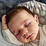 baby, blanket, child, closed_eyes, clothing, cozy, cute, eyelashes, face, head, indoors, infant, peaceful, pillow, portrait, resting, skin, sleeping, soft, toddler