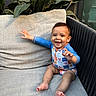 baby, child, smiling, onesie, sitting, cushion, sofa, outdoor, plant, greenery, happy, infant, furniture, portrait, cute, hand, feet, face, relaxing, cozy
