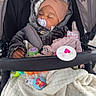baby, stroller, sleeping, pacifier, hat, jacket, blanket, toy, child, cozy, infant, outdoor, cute, bundledup, nap, soft, colorful, peaceful, person, warm