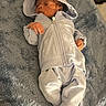 baby, infant, hoodie, pants, blanket, sleeping, baby_monitor, bib, gray, cozy, soft_texture, indoor, child, newborn, resting, clothing, cute, small_hand, footwear, relaxing