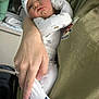 Nicholas joined the competition — help win amazing prizes! baby, newborn, infant, pajamas, hat, socks, whale_pattern, hand, arm, person, indoor, clothing, holding, cute, sleepwear, child, skin, face, portrait, resting