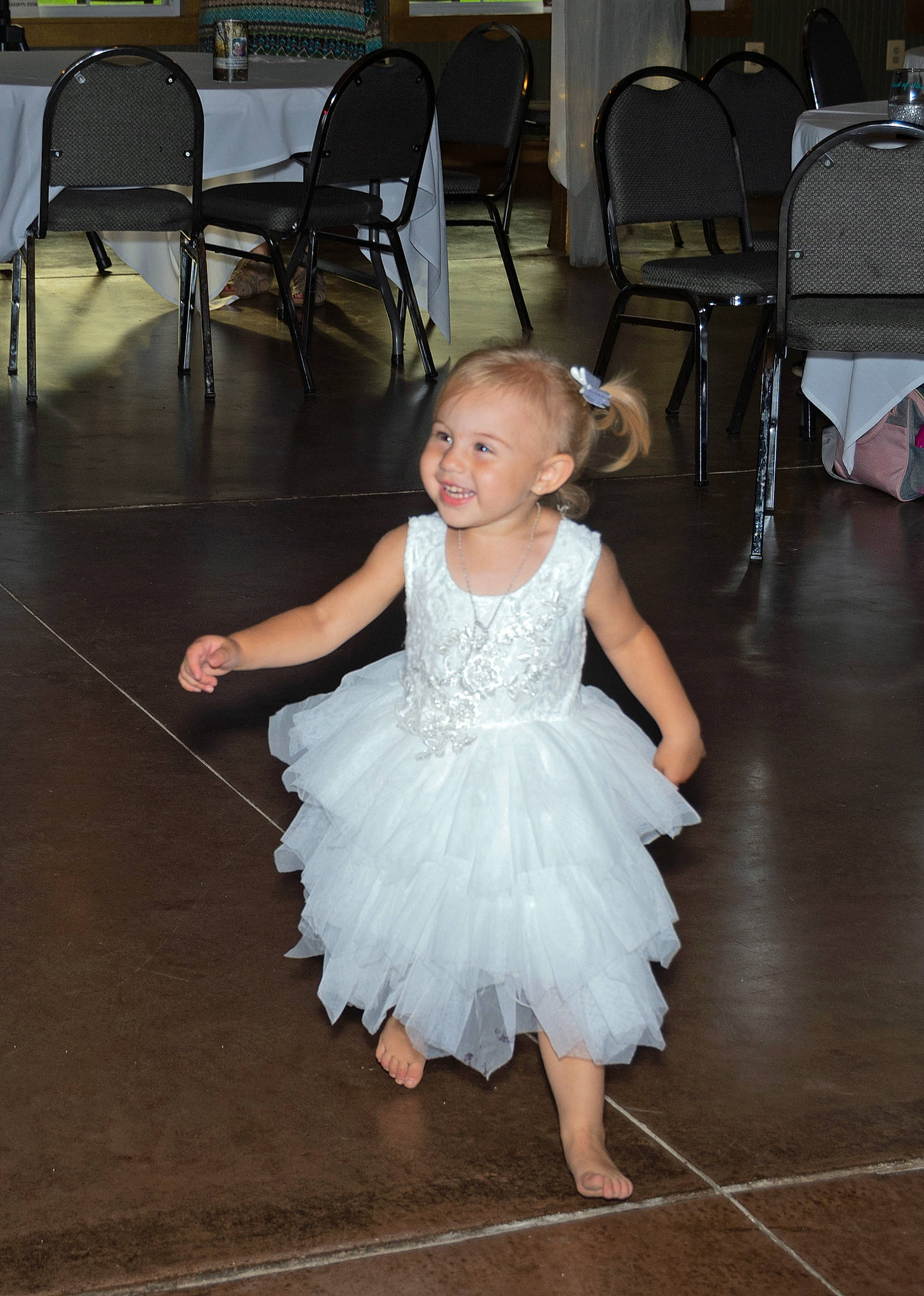 Lilliana is registered to the contest to win money with this photo: baby_toddler_clothing, bridal_party_dress, chair, child, dance, dress, embellishment, entertainment, event, flash_photography, floor, flooring, formal_wear, fun, gown, happy, joint, joy, person, shoulder