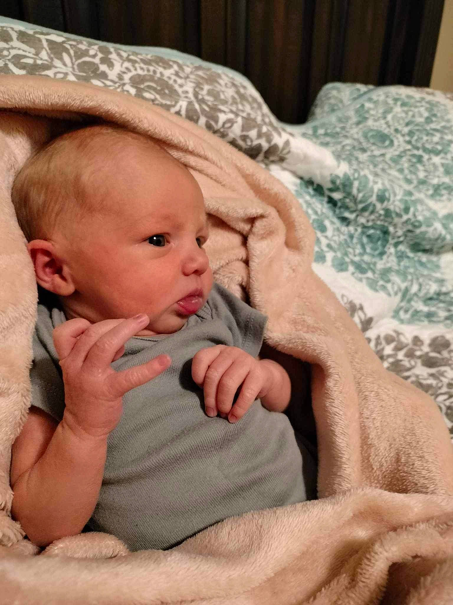 Lucas is registered to the contest to win money with this photo: baby, baby_products, baby_toddler_clothing, cheek, child, chin, comfort, eye, eyelash, face, gesture, iris, linens, lip, mammal, nail, person, sitting, skin, textile