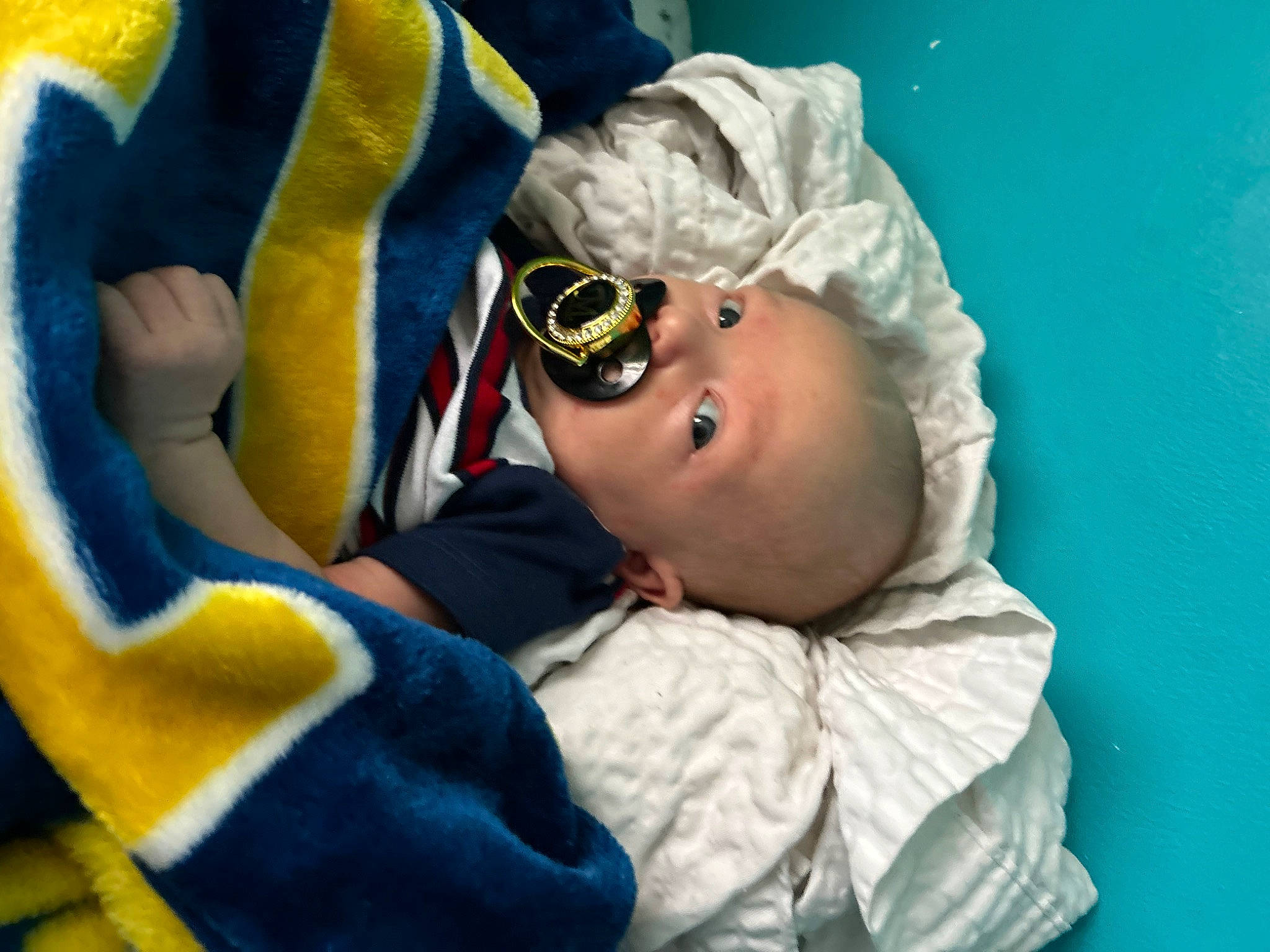 Lucas is registered to the contest to win money with this photo: baby, baby_products, child, comfort, event, eye, eyewear, fun, glasses, goggles, hat, linens, person, personal_protective_equipment, room, sleep, smile, sunglasses, toddler, vision_care