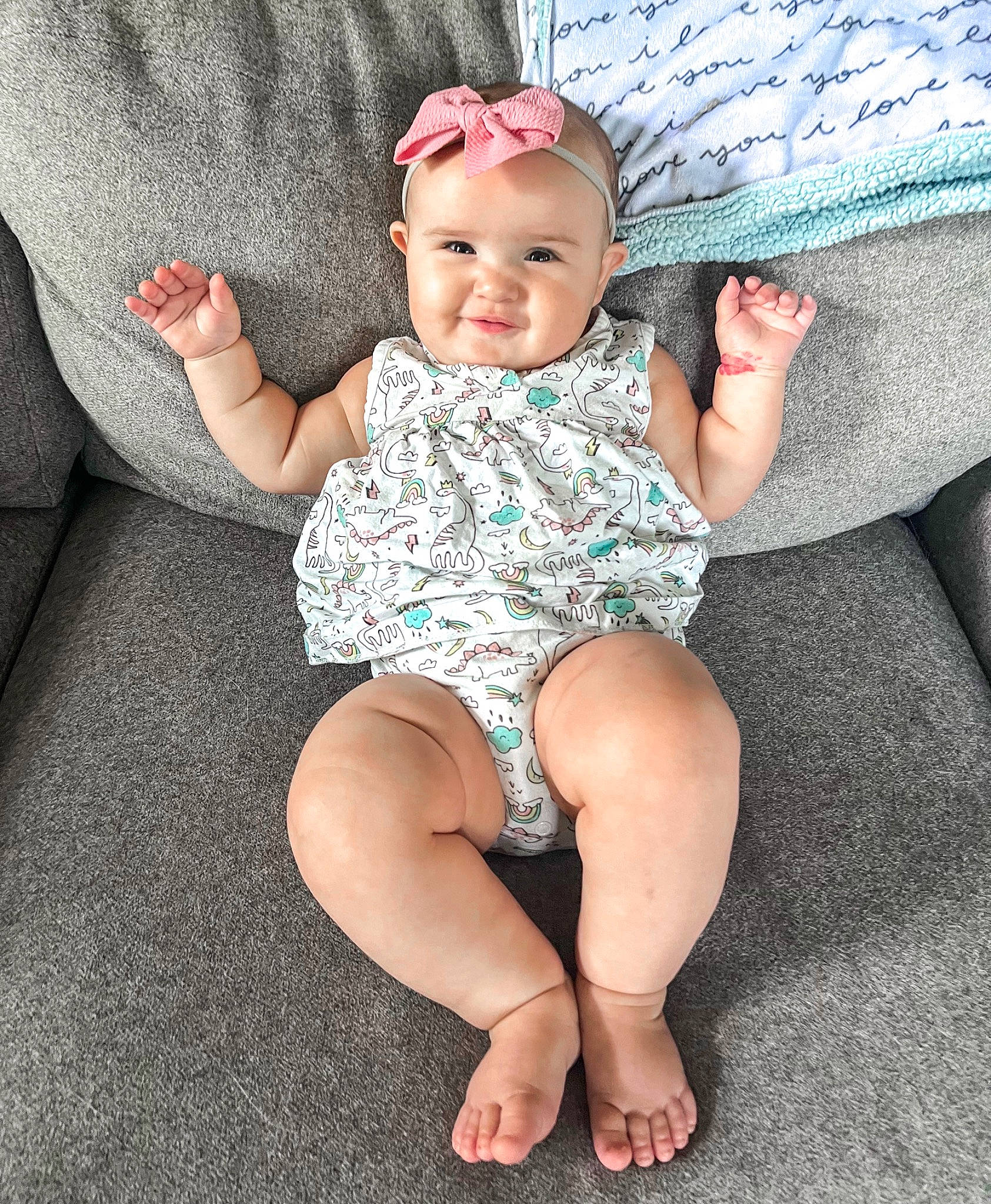 Addison joined the competition — help win amazing prizes! baby, baby_toddler_clothing, barefoot, child, comfort, finger, foot, grass, headwear, human_leg, knee, lap, leg, pattern, person, pink, sitting, skin, sleeve, smile