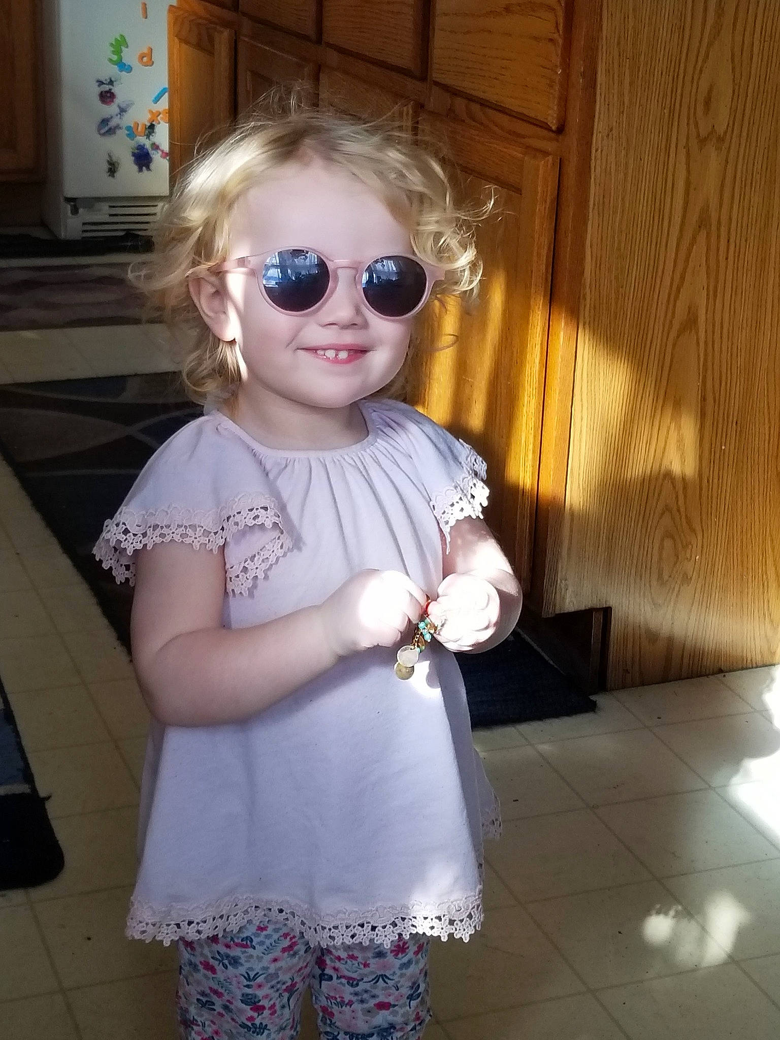 Brooklyn is registered to the contest to win money with this photo: baby_toddler_clothing, blond, day_dress, door, dress, eyewear, glasses, goggles, joy, outerwear, person, pink, purple, shoulder, skin, sleeve, smile, standing, sunglasses, toddler