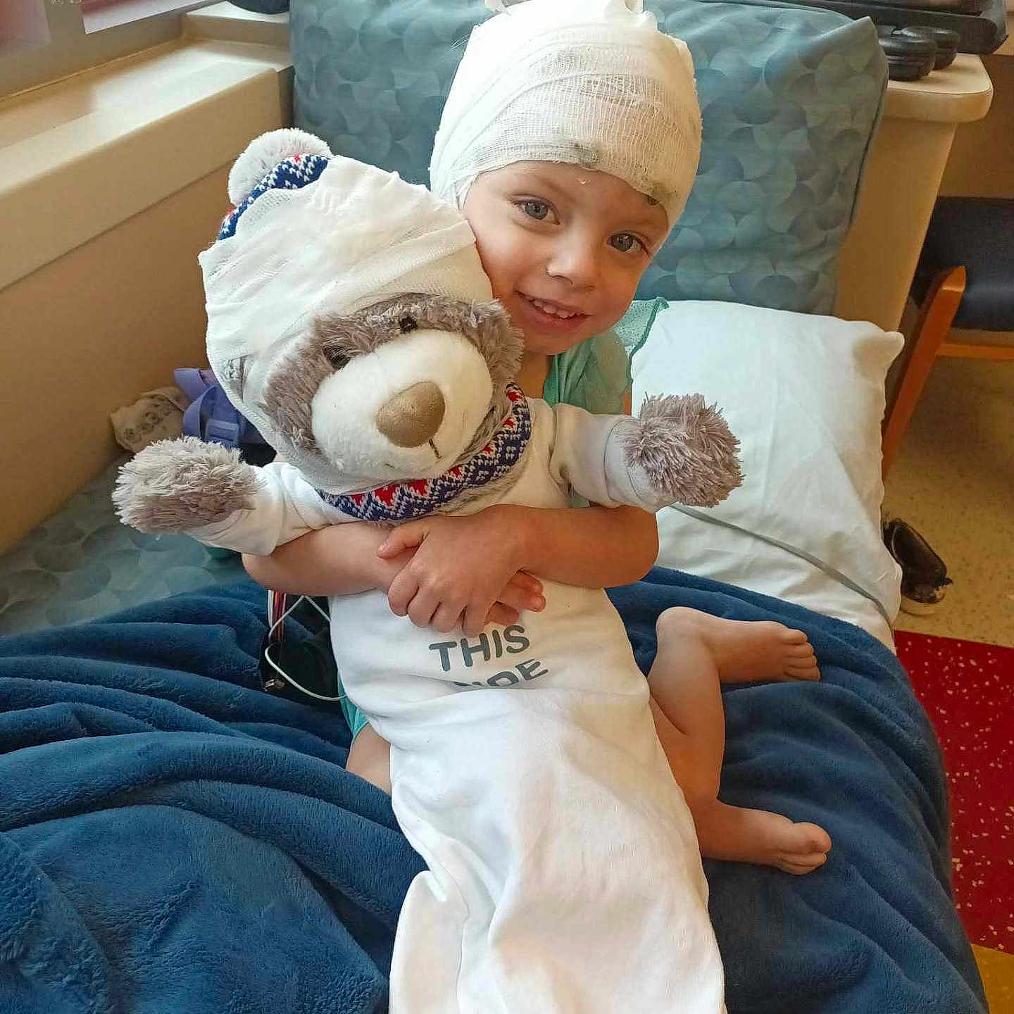 Leanna is registered to the contest to win money with this photo: architecture, baby, blanket, building, cap, clothing, couch, cushion, face, furniture, hat, head, homedecor, hospital, indoors, person, photography, pillow, portrait, t_shirt