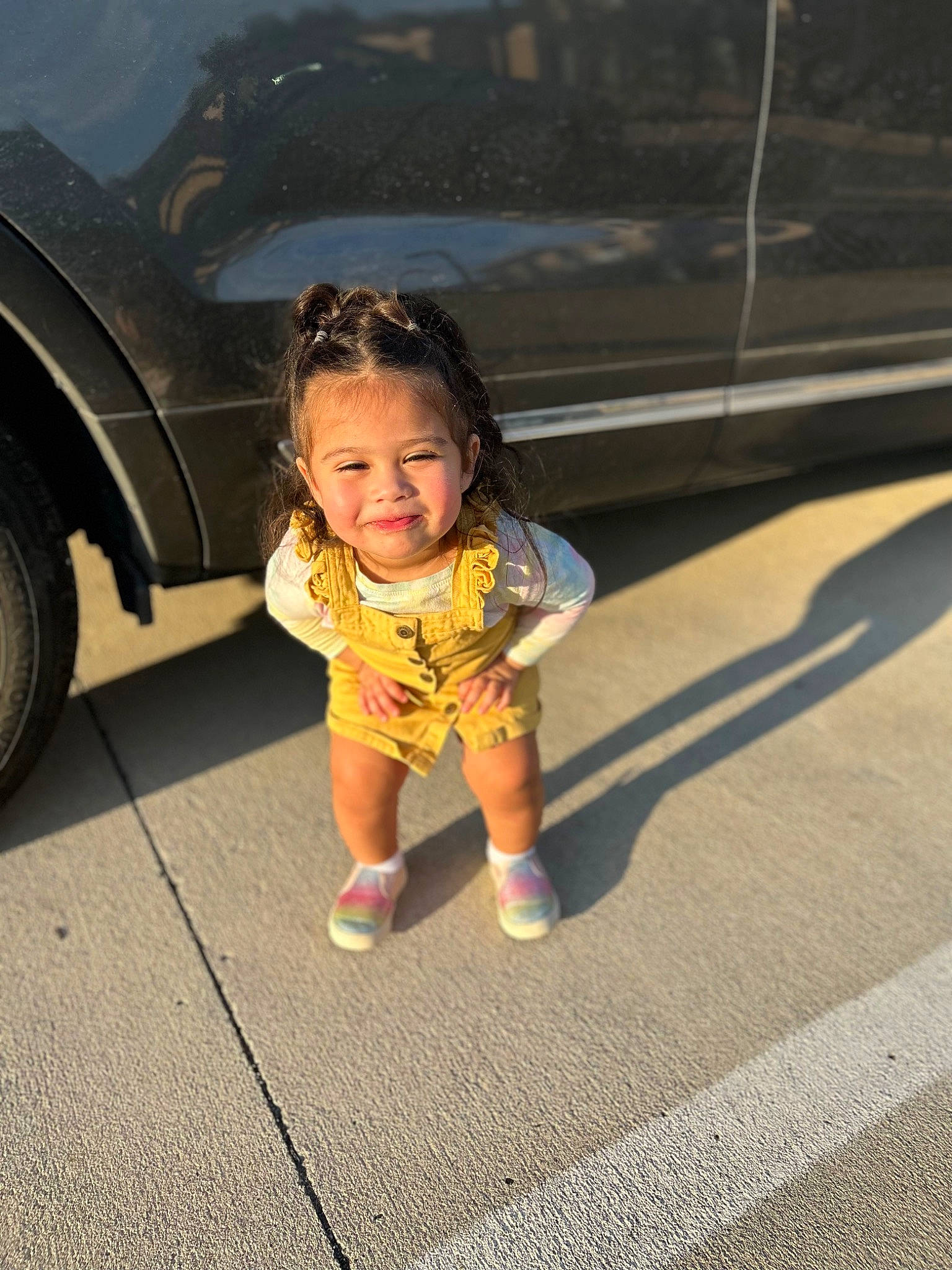 Anabella is registered to the contest to win money with this photo: asphalt, automotive_design, automotive_exterior, automotive_lighting, automotive_tire, bumper, car, facial_expression, fun, grass, happy, joy, motor_vehicle, person, road, road_surface, smile, tints_and_shades, tire, toddler