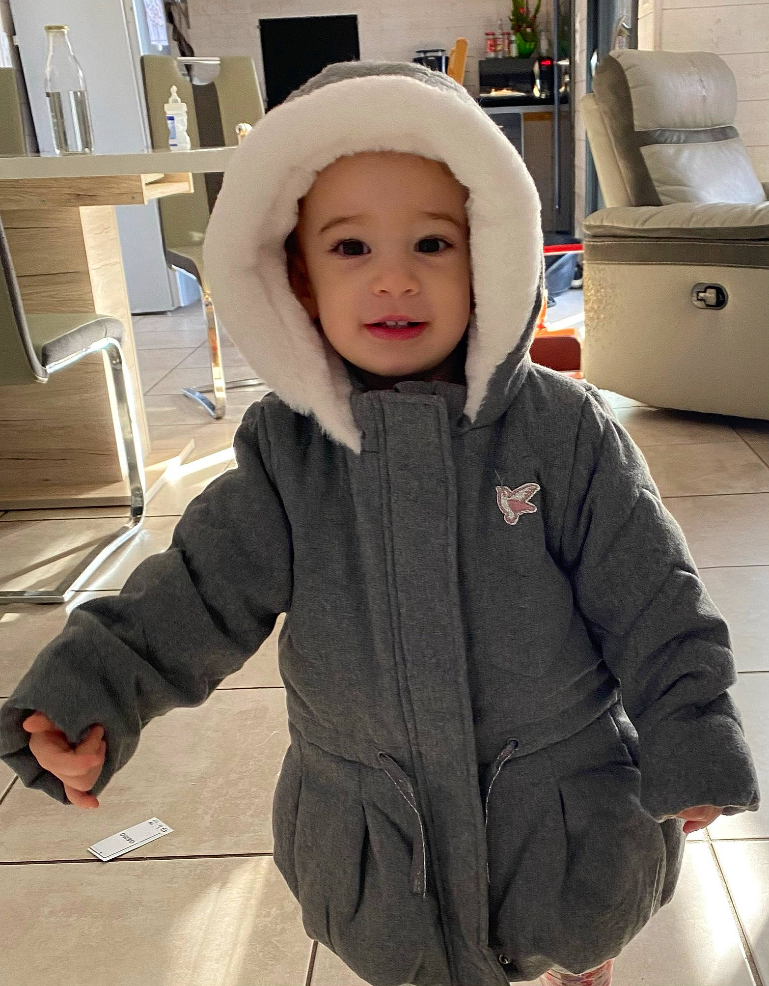 Kylia a rejoint le concours — aidez-le/la à gagner de superbes lots ! baby, baby_toddler_clothing, cap, cheek, child, eye, fashion_accessory, flooring, fur, happy, headwear, hood, outerwear, pattern, person, sitting, sleeve, smile, standing, street_fashion