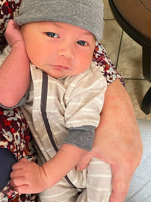 Elvis is registered to the contest to win money with this photo: baby, baby_toddler_clothing, cap, cheek, child, chin, eye, facial_expression, finger, hairstyle, hand, happy, headwear, lip, organ, outerwear, person, pink, skin, sleeve