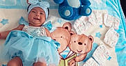 Celeste joined the competition — help win amazing prizes! baby, baby_clothing, bed, blanket, blue_dress, bow, celebration, child, diapers, headband, indoor, infant, lying_down, nursery, photography, playful, portrait, smiling, stitch_plushie, teddy_bears