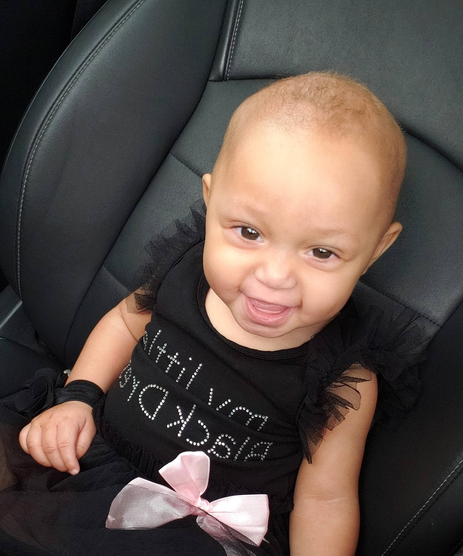 Andria is registered to the contest to win money with this photo: arm, baby, baby_products, car_seat, cheek, child, ear, face, finger, hand, head, material_property, person, photography, pink, product, seat_belt, sitting, skin, smile